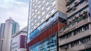 A multi-story building with a modern glass facade, multiple balconies, and a visible sign for "Canton Plaza." - Lodgewood by Nina Hospitality丨Mong Kok (Kowloon)