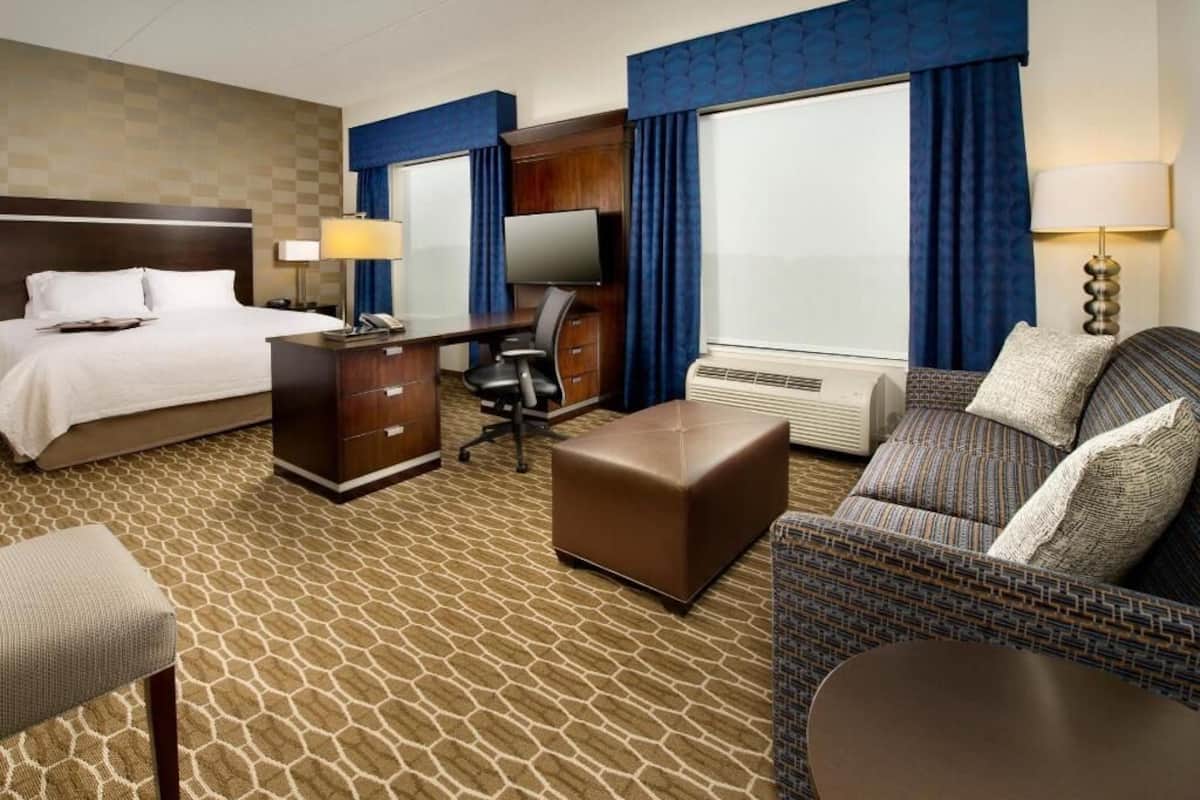 Premium bedding, desk, laptop workspace, blackout drapes
