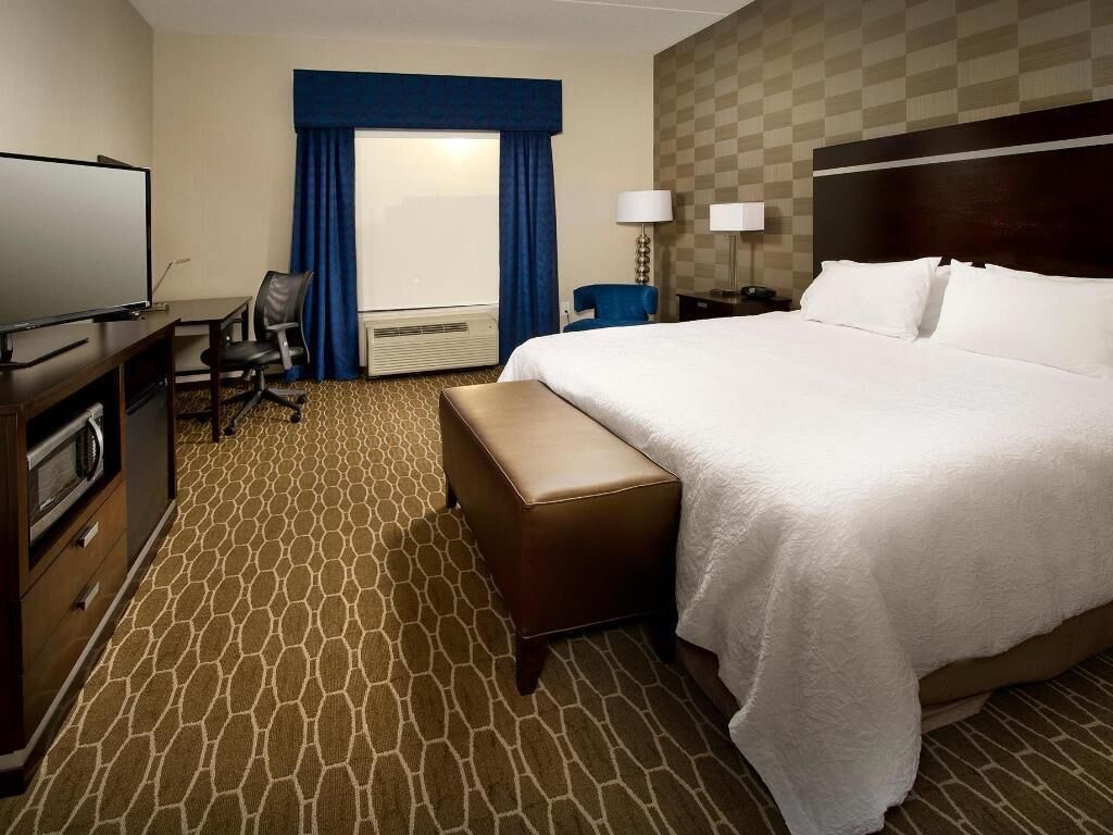 Premium bedding, desk, laptop workspace, blackout drapes
