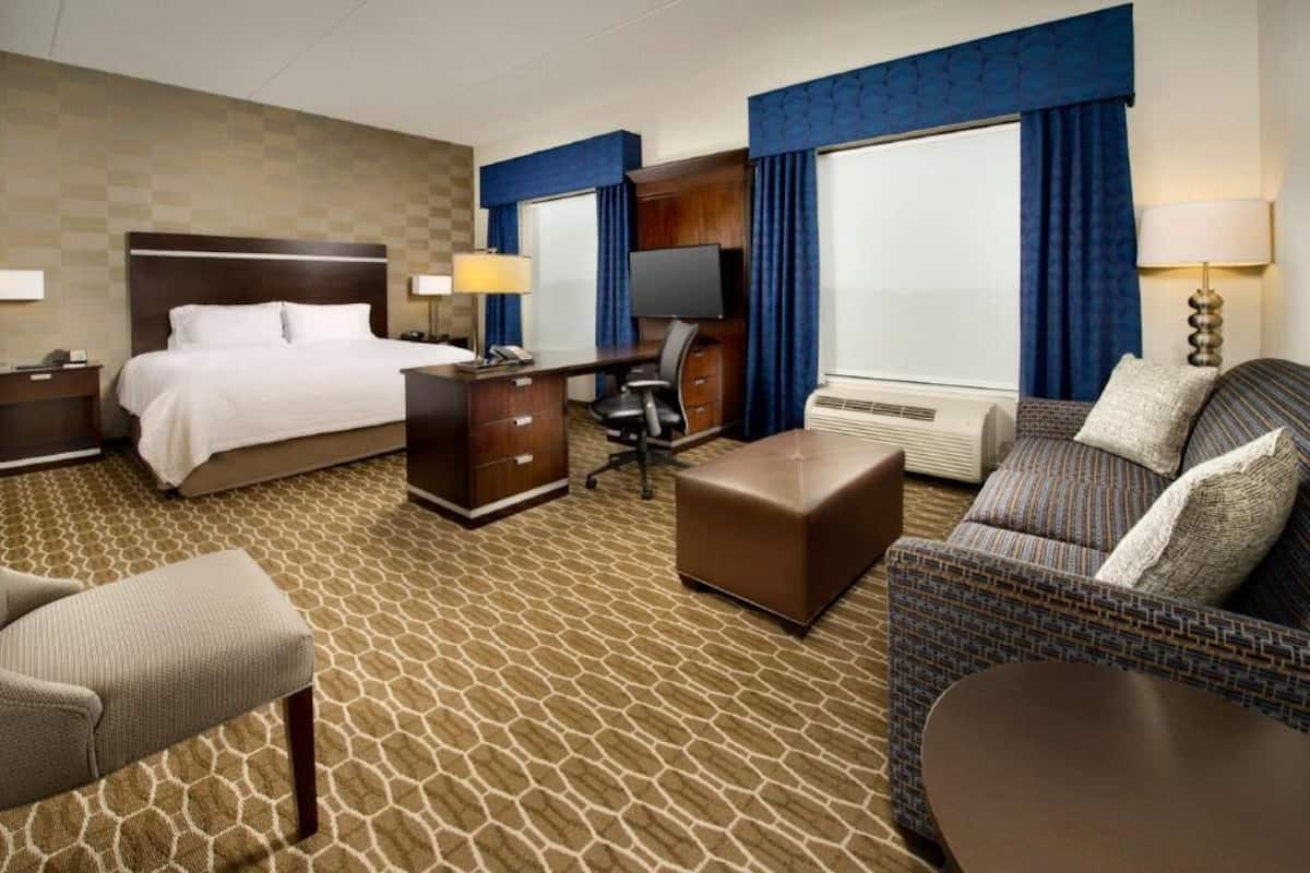 Premium bedding, desk, laptop workspace, blackout drapes