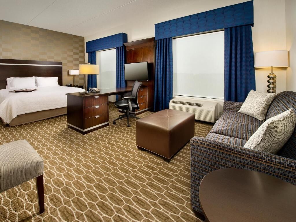 Premium bedding, desk, laptop workspace, blackout drapes