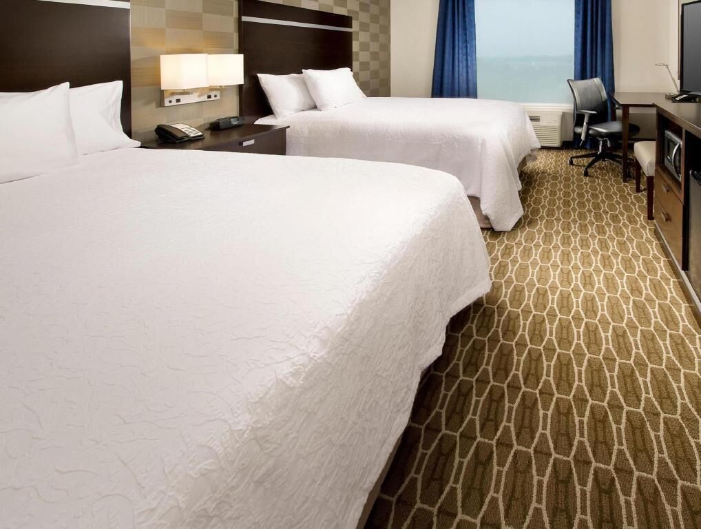 Premium bedding, desk, laptop workspace, blackout drapes