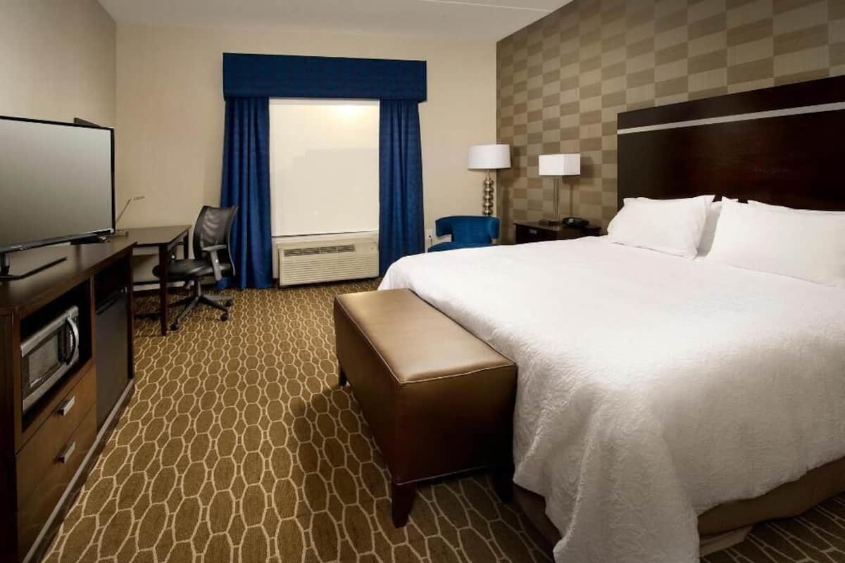 Premium bedding, desk, laptop workspace, blackout drapes