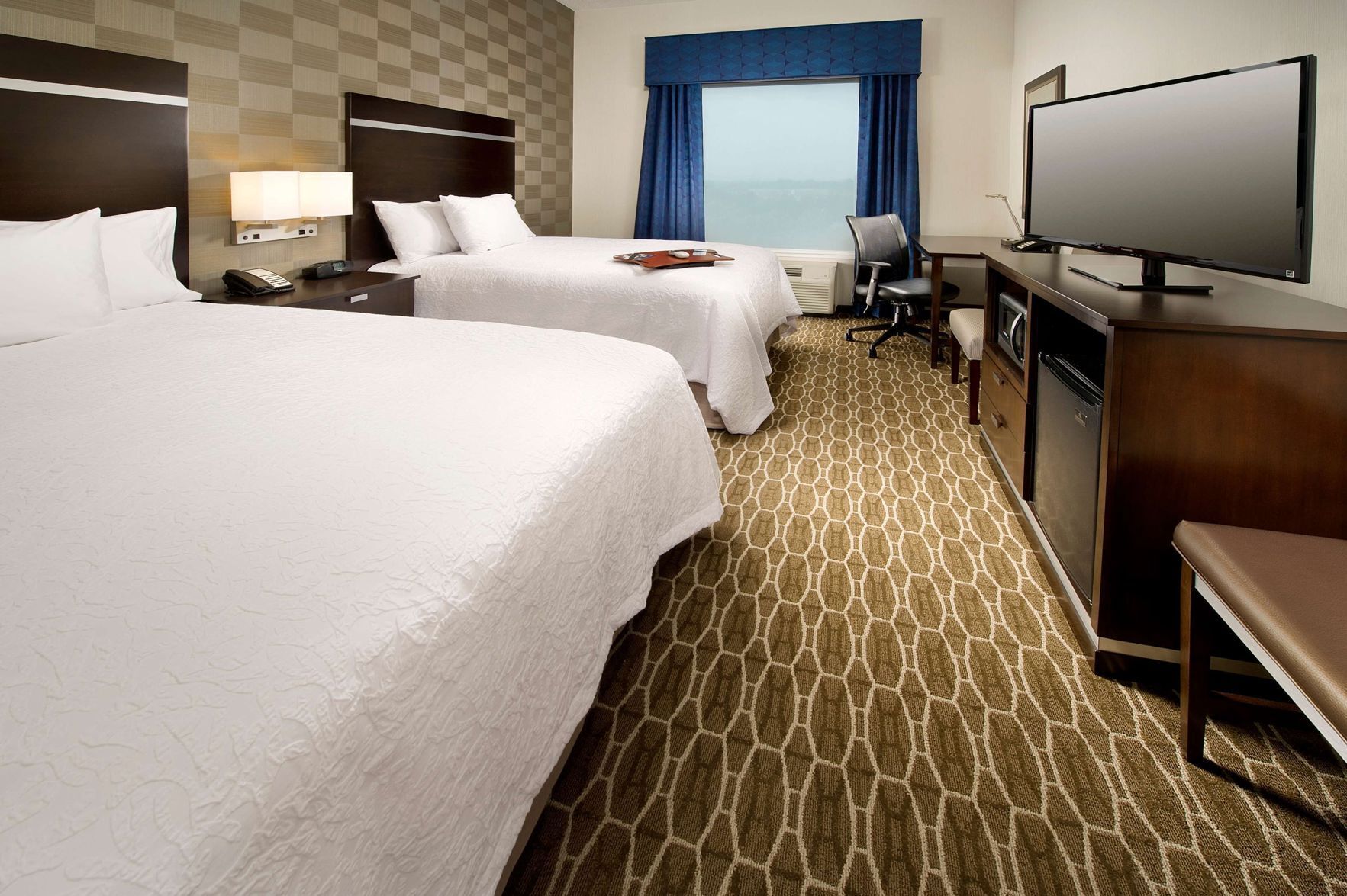 Premium bedding, desk, laptop workspace, blackout drapes