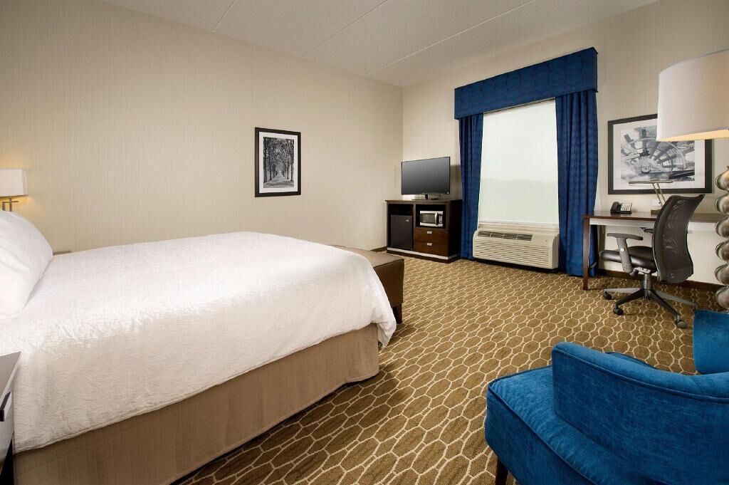 Premium bedding, desk, laptop workspace, blackout drapes