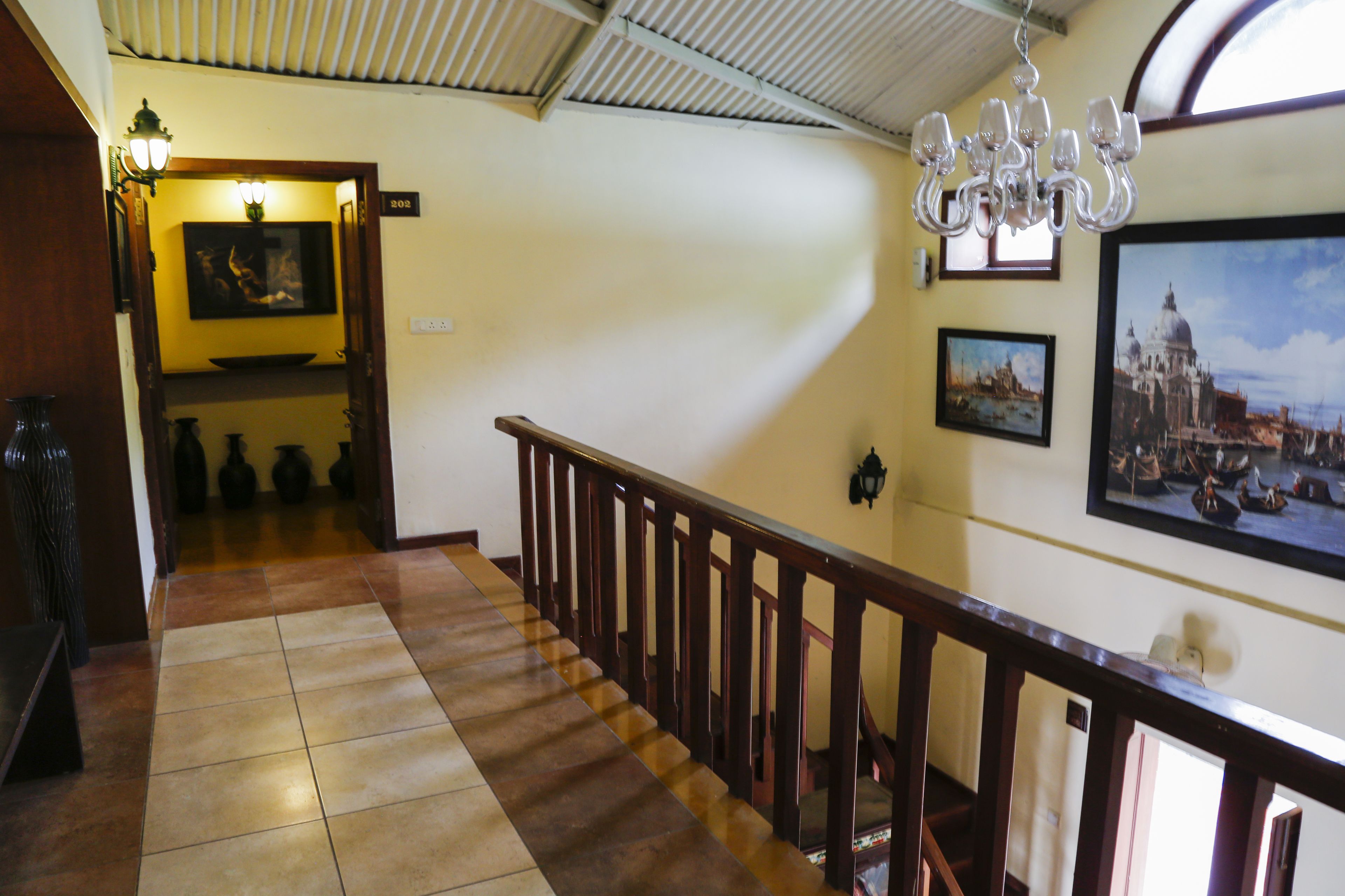 A staircase with wooden railings and a chandelier.