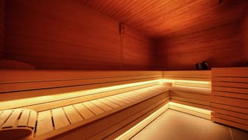 A sauna with wooden benches and a tiled floor.