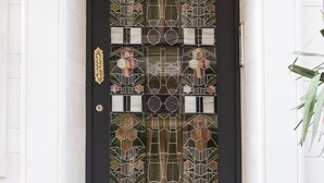 A black door with a stained glass design, a white door frame, and a small plaque with the number 116. - Villa Pera Suite Hotel (Istanbul)
