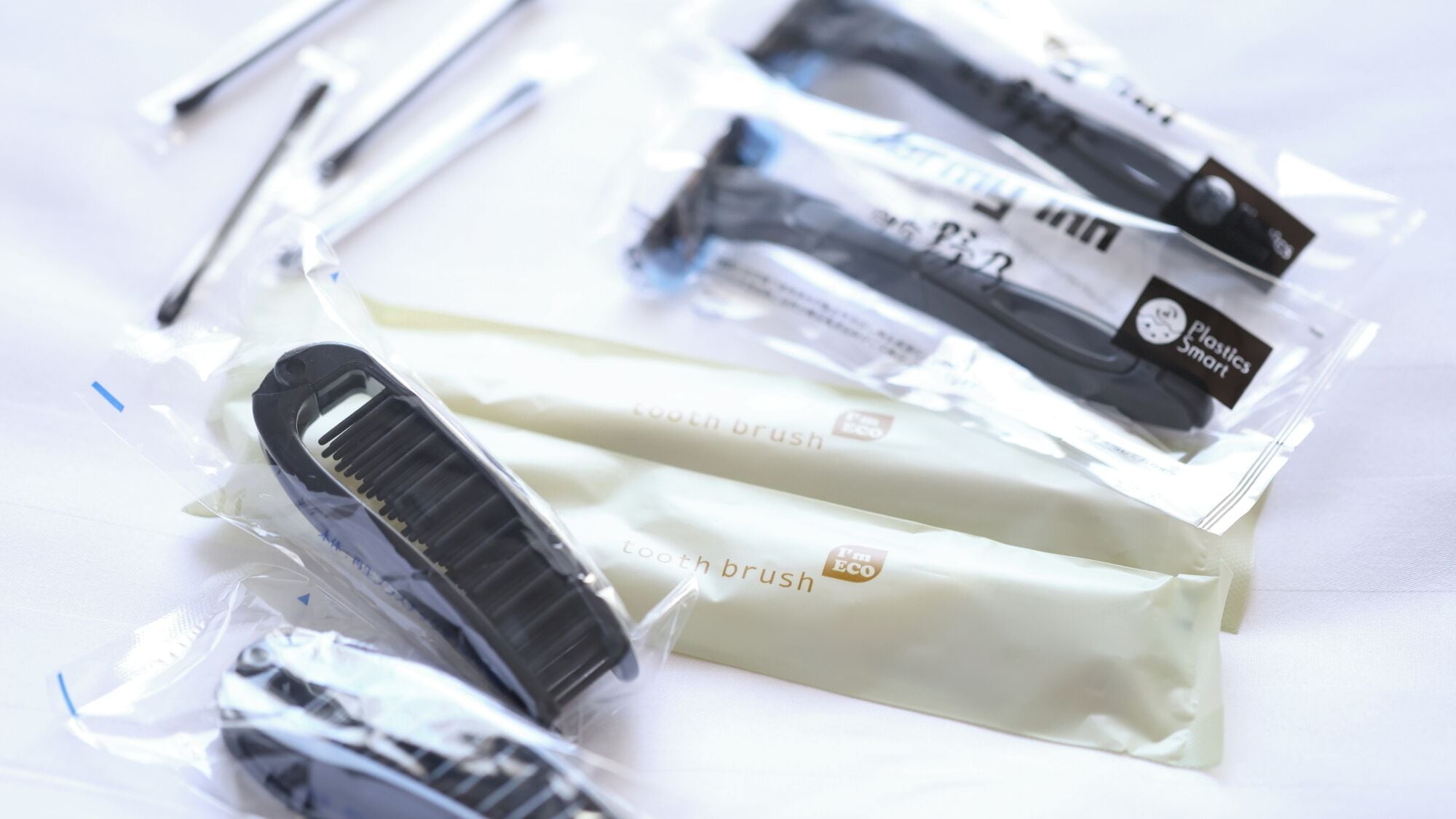 A collection of packaged items, including toothbrushes and a hairbrush, with visible branding and packaging.