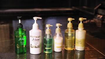 A selection of personal care products on a reflective surface.