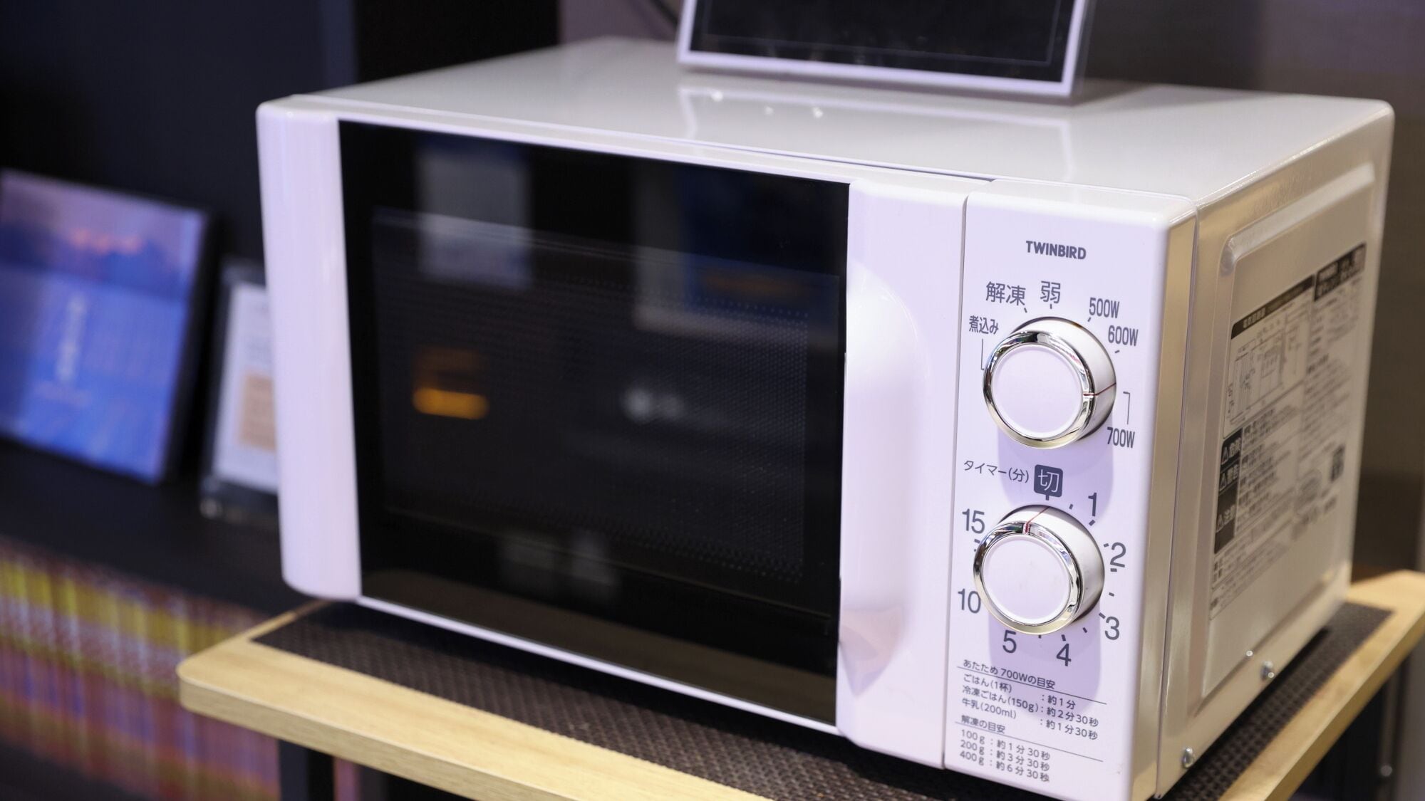 A white microwave oven with two dials and a digital display on top.