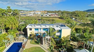 Enjoy a tranquil retreat with a rooftop solar array, pool, and lush surroundings.