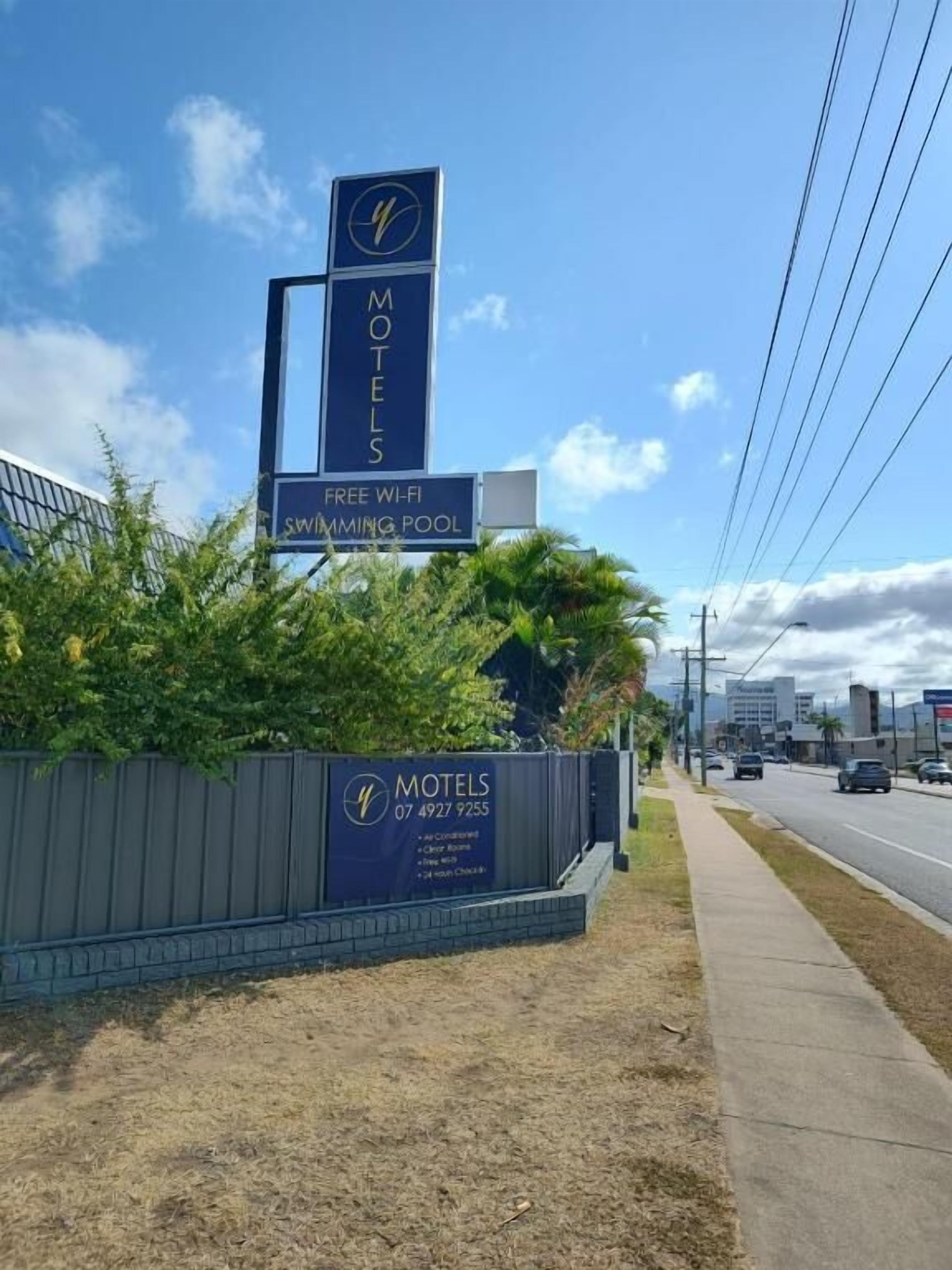 A motel sign with amenities including free Wi-Fi and a swimming pool.