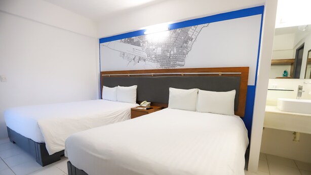 A hotel room with two beds, a nightstand with a phone, and a large map on the wall. - TRYP by Wyndham Chetumal (Chetumal)