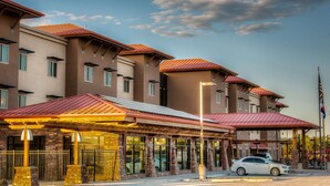 A multi-story hotel with a red roof, large windows, and a covered entrance area. - Hampton Inn & Suites Boulder-North (Boulder)