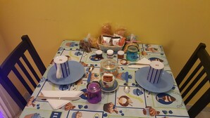 A dining table set with plates, cups, and various food items. - Domina Romae B&B (Rome)