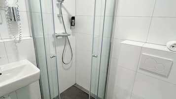 Vierpersoonskamer | Badkamer | Een douche, gratis toiletartikelen, een haardroger, handdoeken