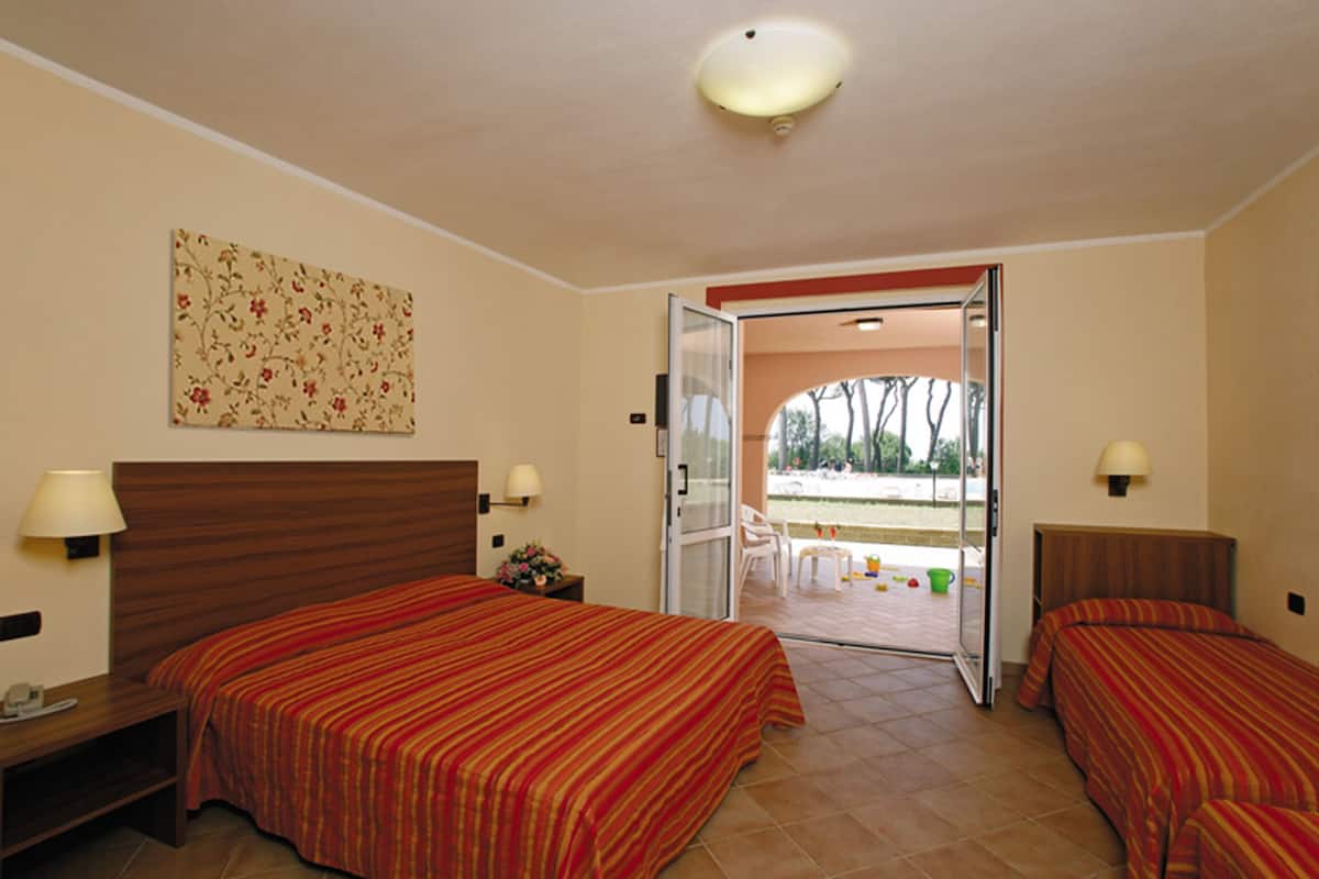 Standard Quadruple Room, Balcony, Pool View | Minibar, in-room safe, desk, soundproofing