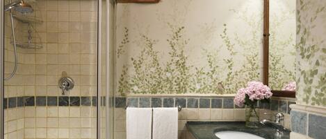A bathroom with a shower, a sink, and a mirror.
