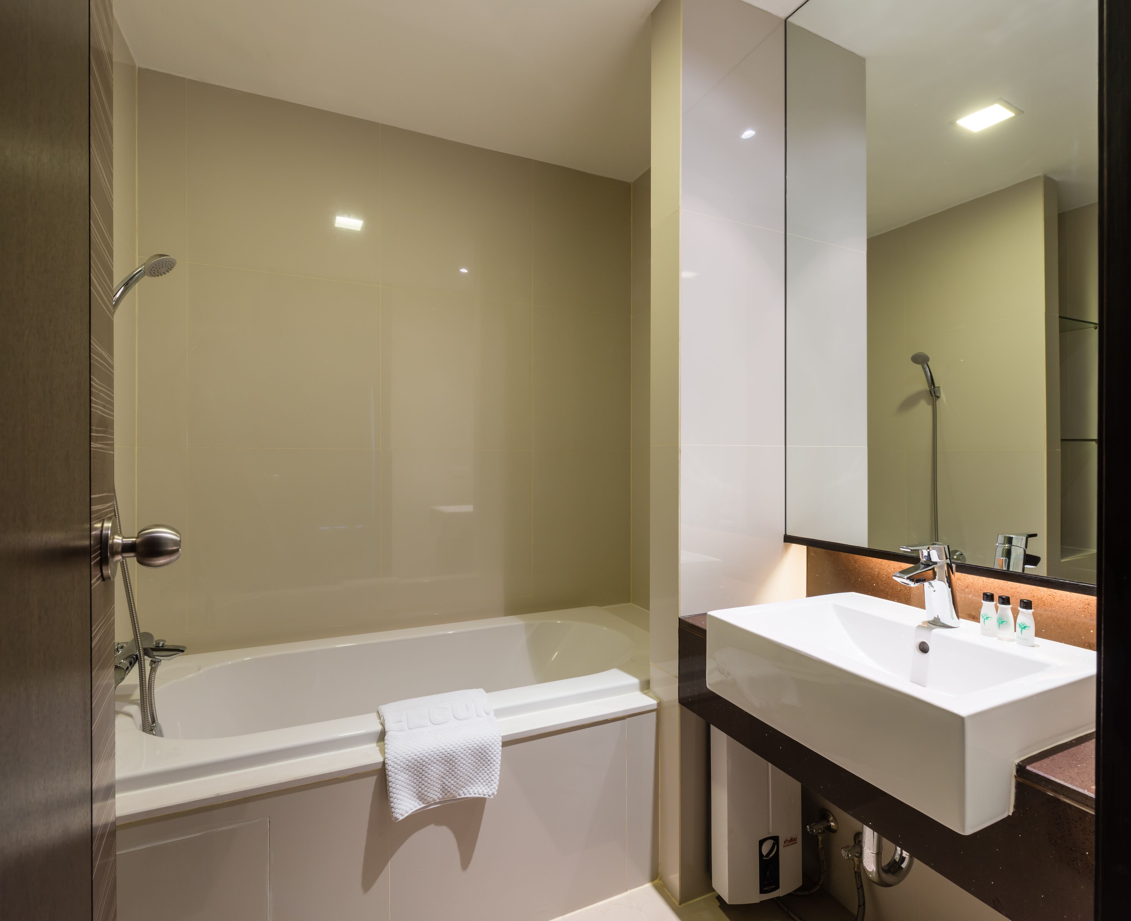Un baño moderno con bañera, lavabo y espejo.