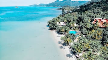 On the beach, white sand, sun-loungers, beach umbrellas