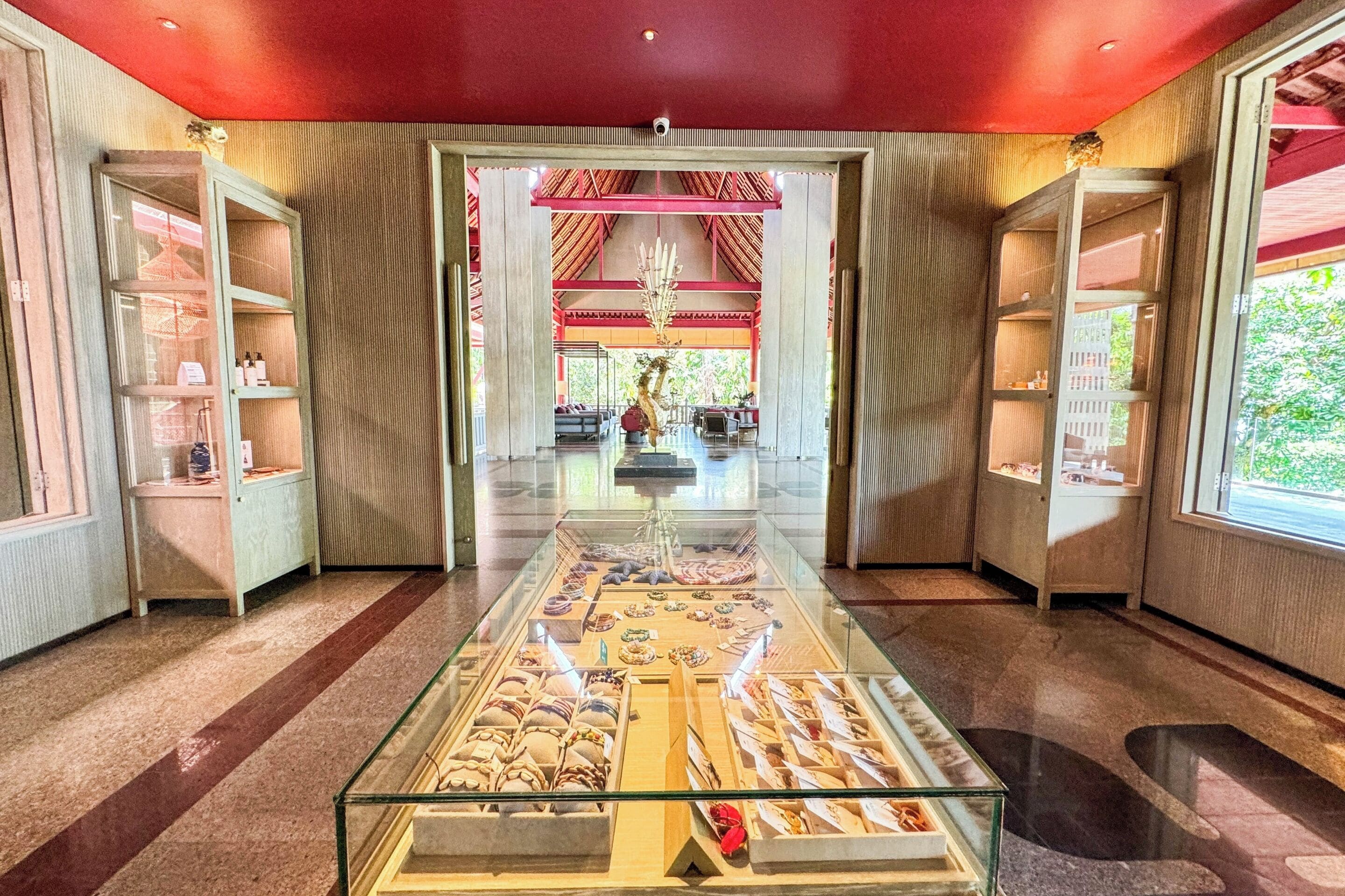 A spacious lobby with a central display of pastries and a view of the reception area.