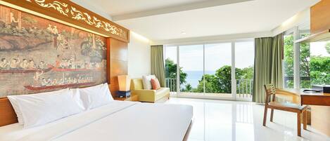 A hotel room with a large bed, a desk, a chair, a sofa, and a balcony with a view.