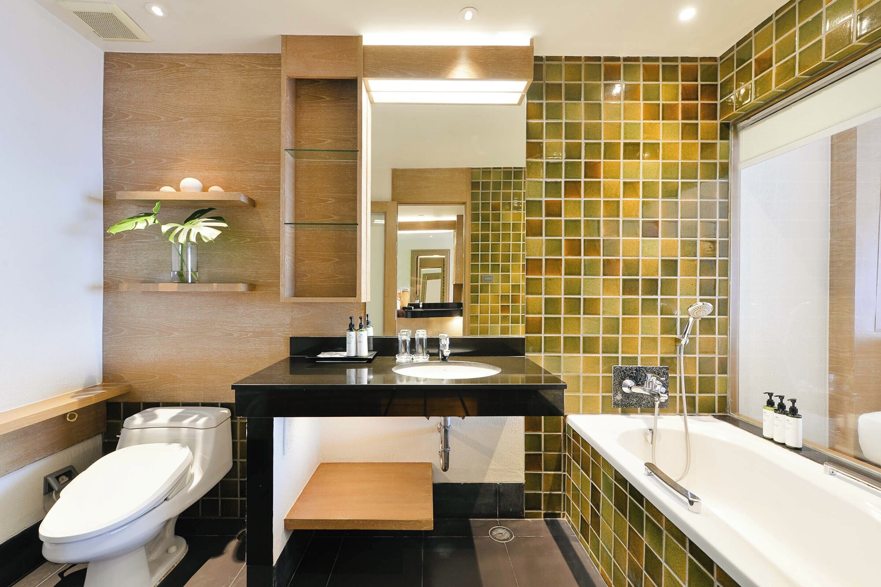 A modern bathroom with a toilet, sink, and bathtub.