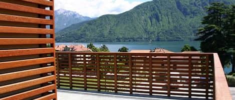 Eine Terrasse mit Blick auf einen See und Berge.