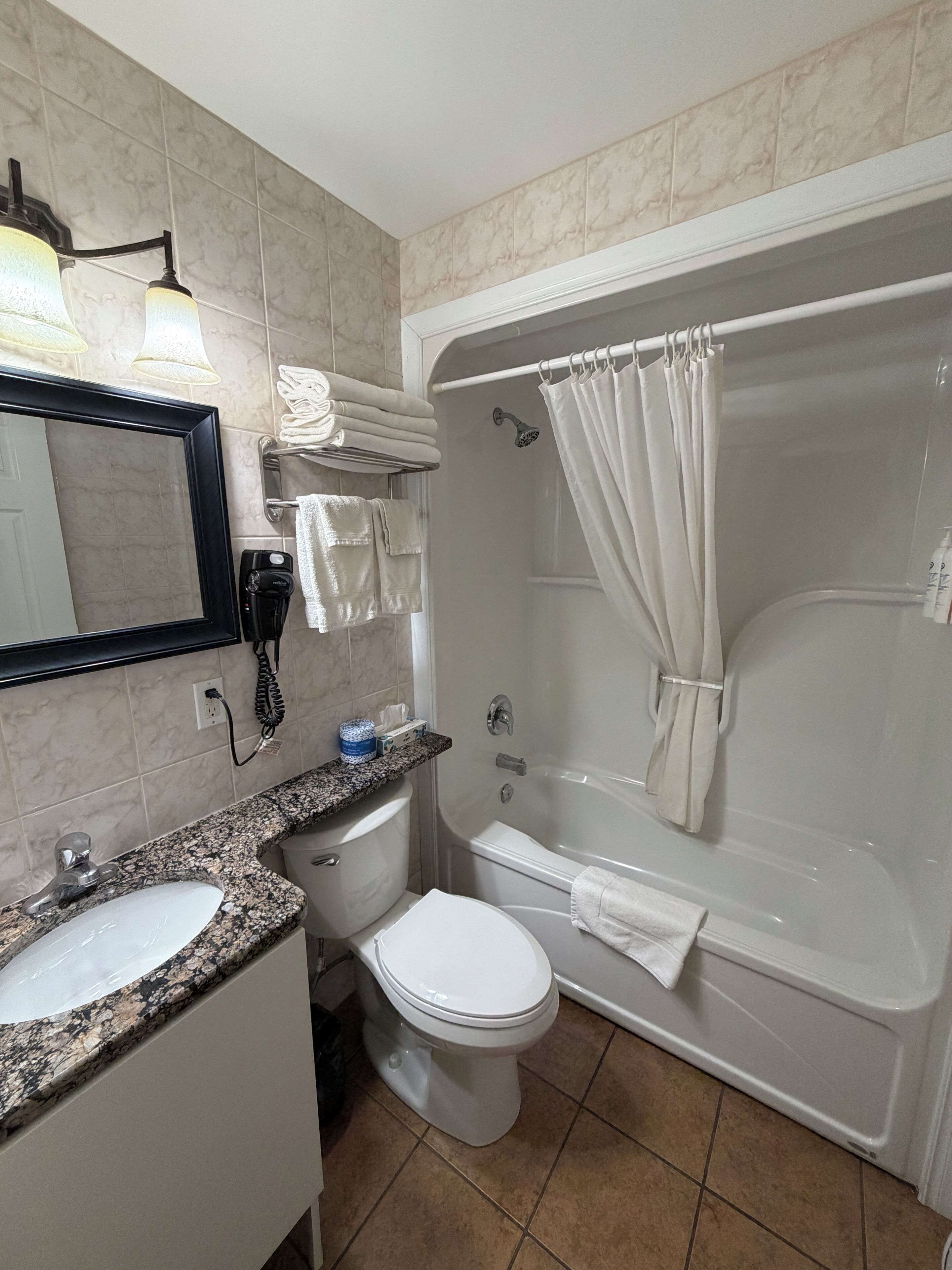 A bathroom with a sink, toilet, and bathtub.