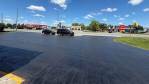 A parking lot with a McDonald's and KFC restaurant, a gas station, and a clear blue sky. - Perth Plaza Inn & Suites (Perth)
