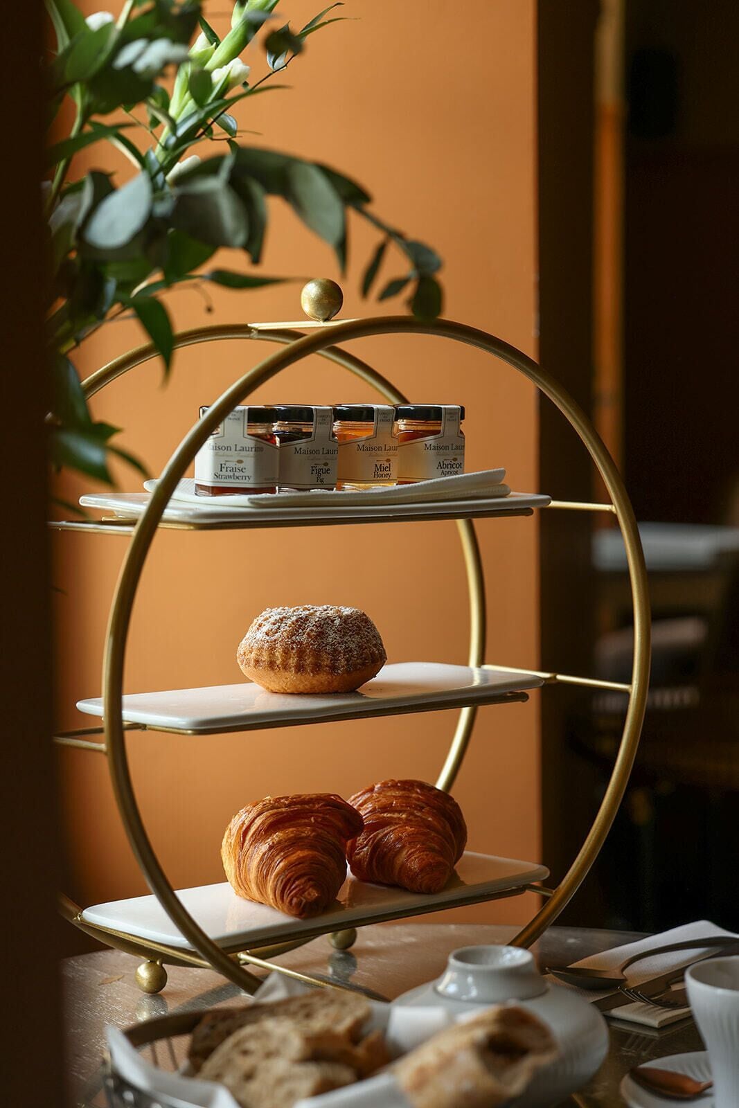 A dessert display with pastries and honey jars.