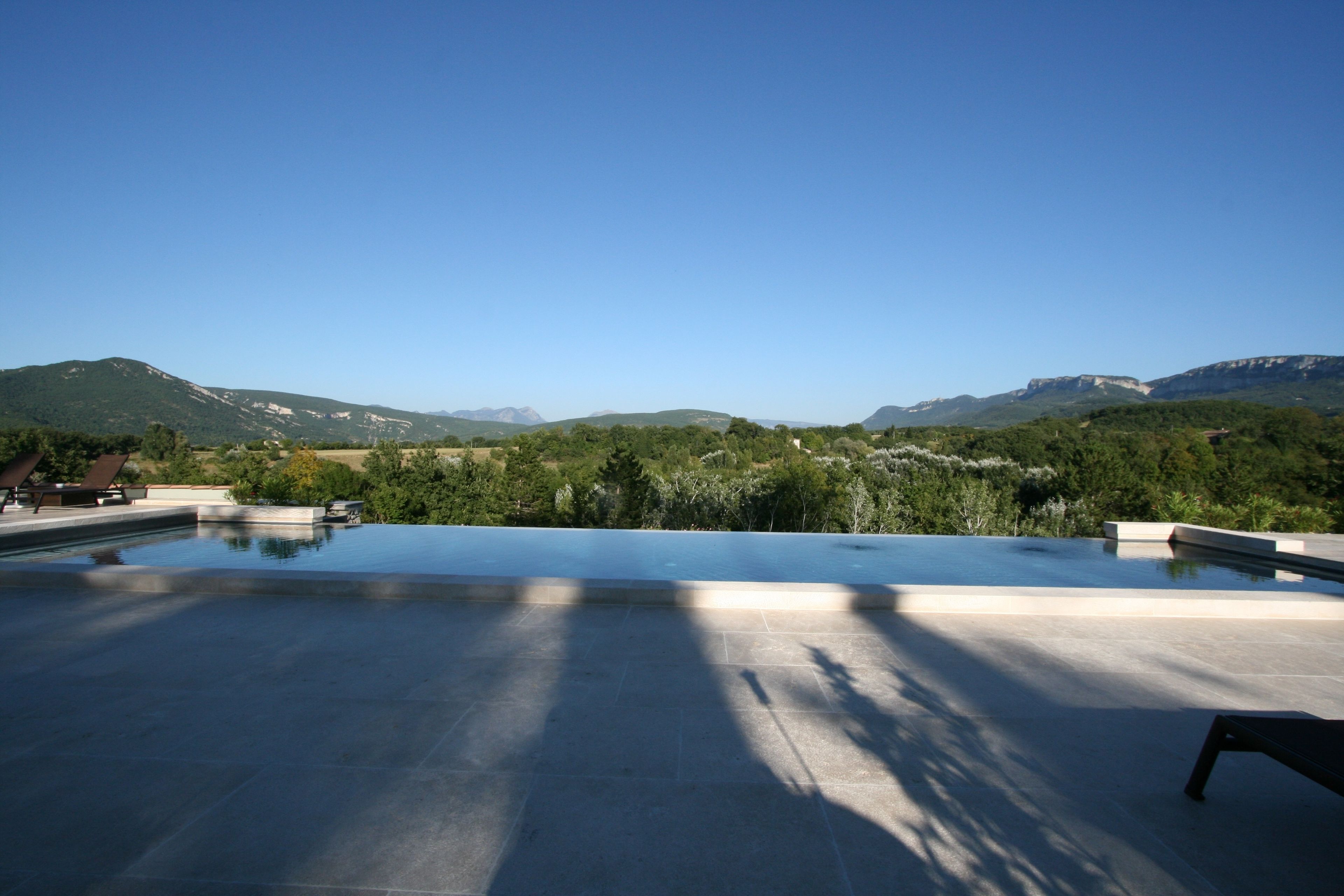 An infinity pool with a view of mountains.
