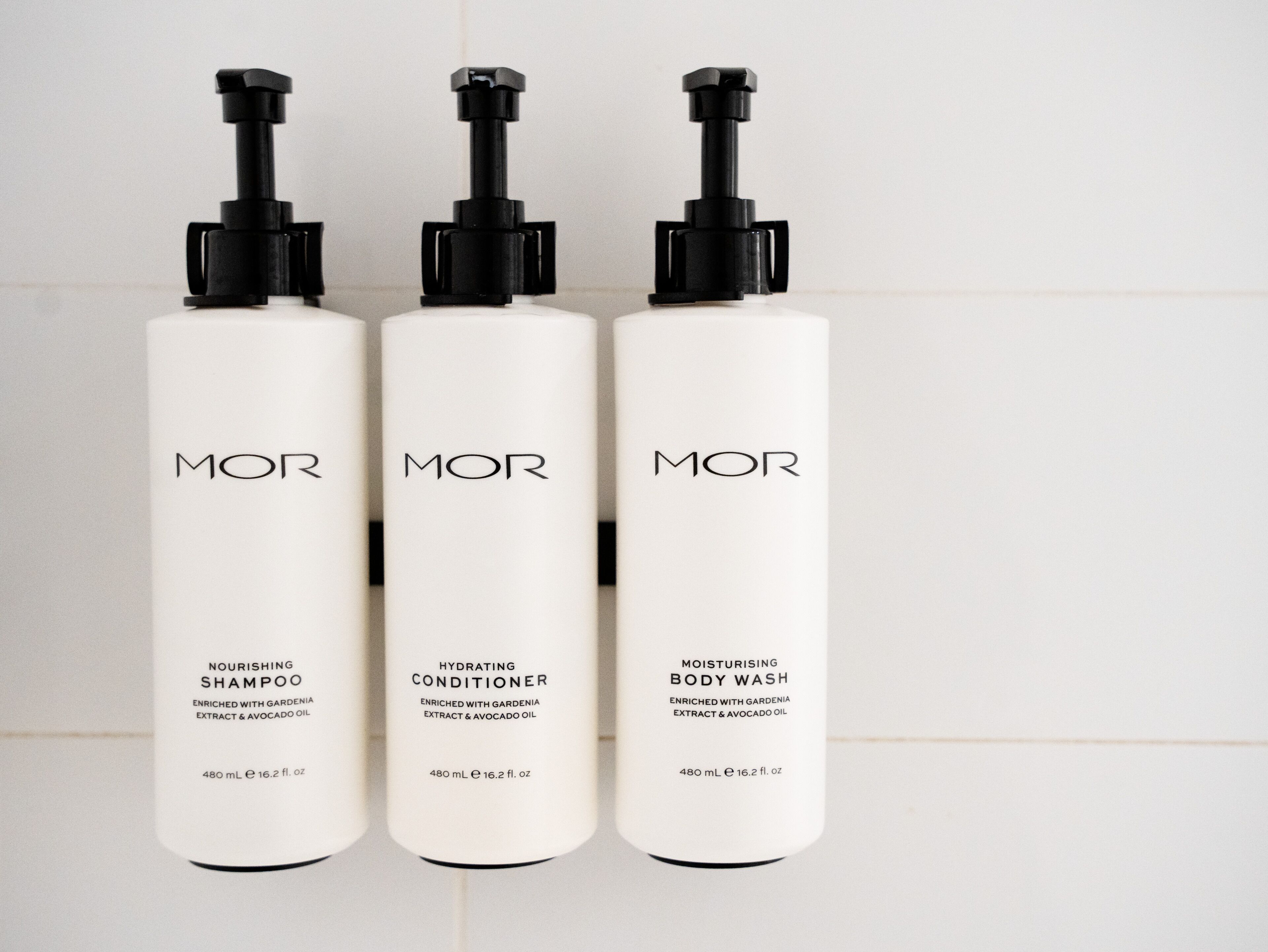 Three white bottles with black pumps, labeled 'MOR', each containing 480 mL of product.