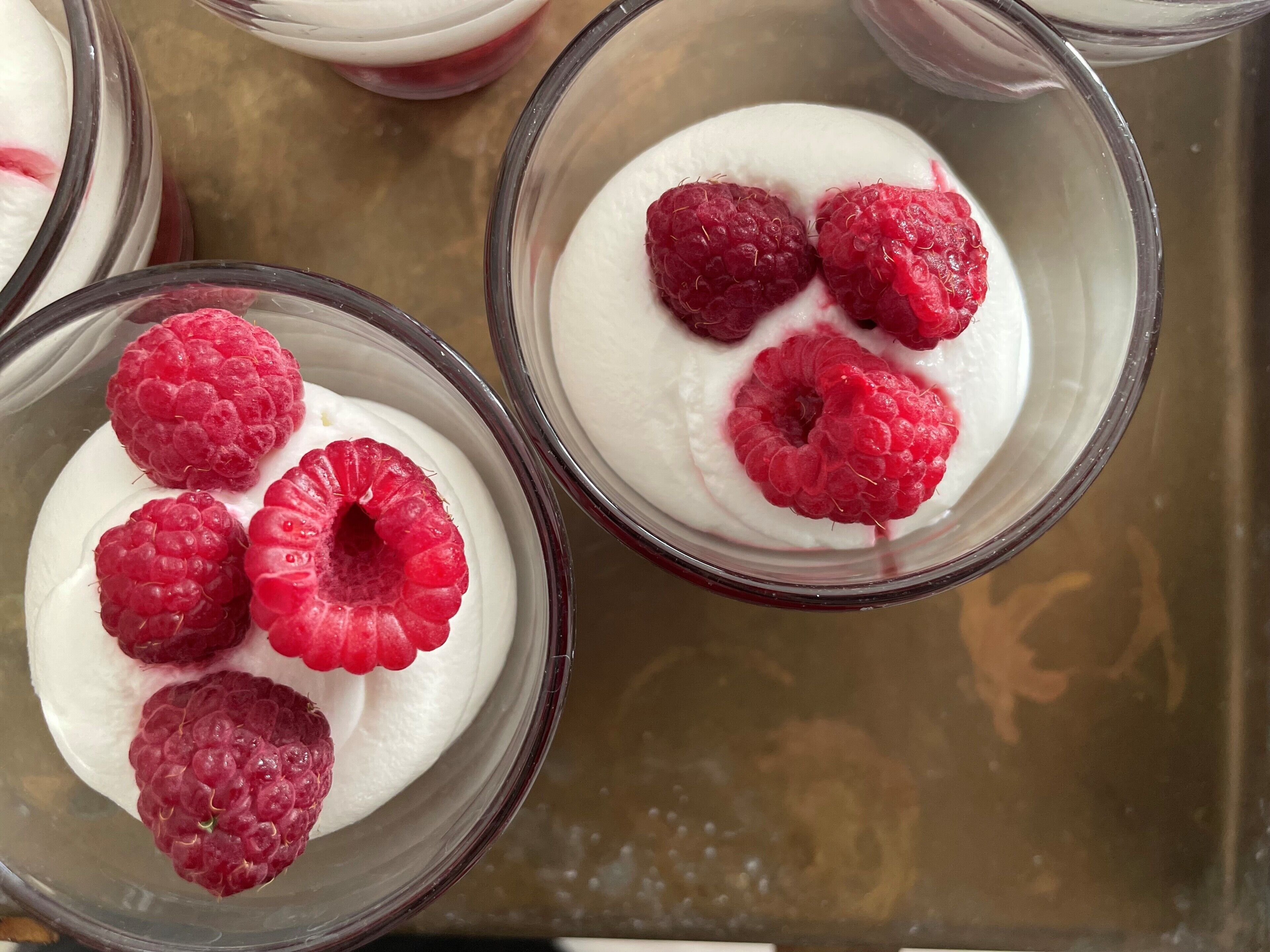 Tres tazones de postre con frambuesas por encima.