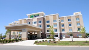 A Holiday Inn Express hotel with a modern design, featuring a covered entrance, multiple floors, and a parking lot. - Holiday Inn Express Covington-Madisonville by IHG (Covington)