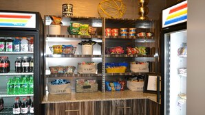 A snack and drink display with various items like soda, chips, and snacks. - Holiday Inn Express Covington-Madisonville by IHG (Covington)
