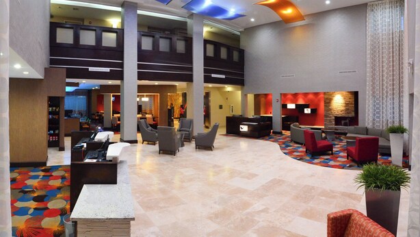 A spacious lobby with a reception desk, multiple seating areas, and a high ceiling with recessed lighting. - Fairfield Inn & Suites Houston-North Spring (Spring)