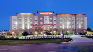 A multi-story hotel with a prominent marquee sign, a landscaped entrance, and a parking area. - Fairfield Inn & Suites Houston-North Spring (Spring)
