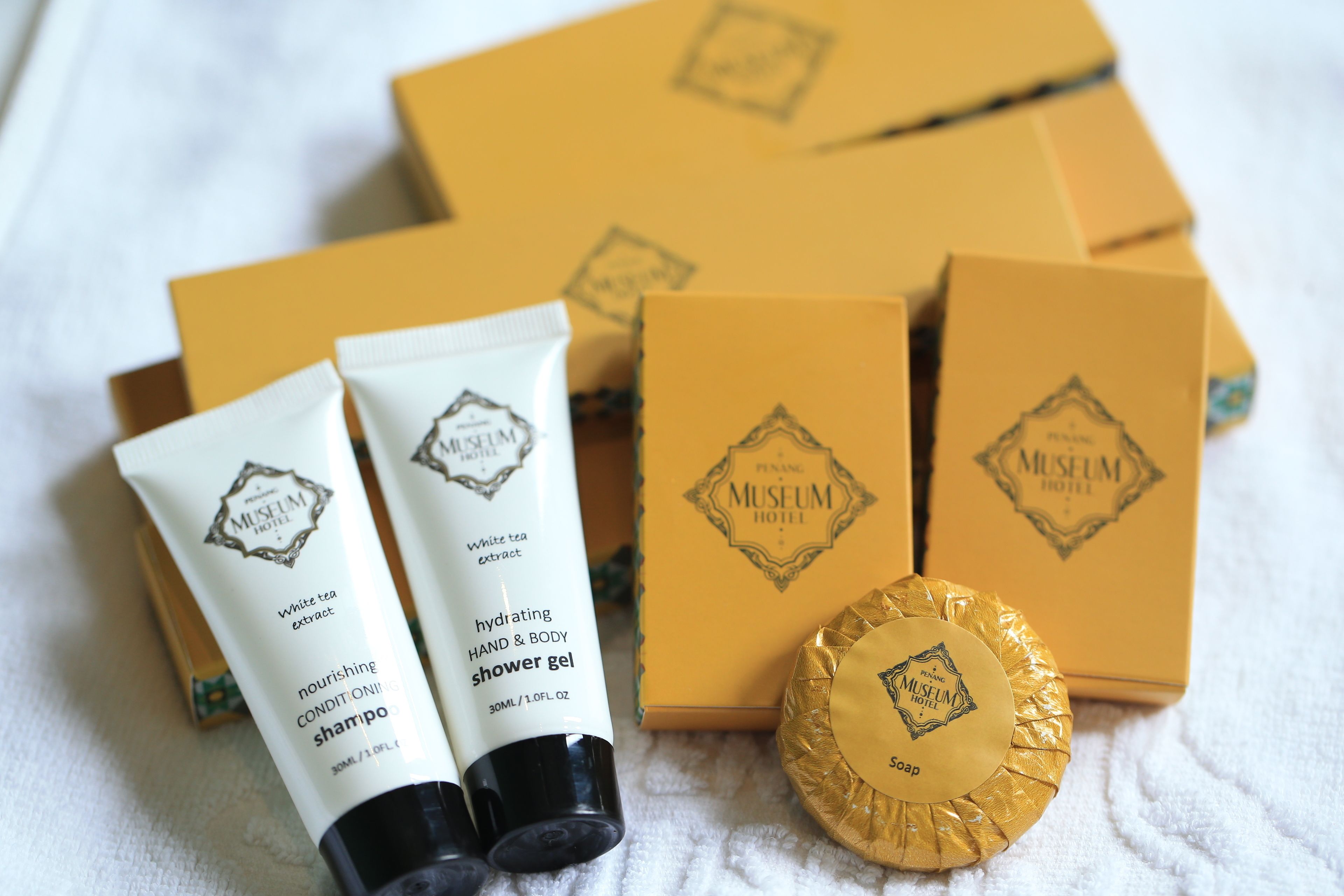 Toiletries including a shower gel and a soap bar, with boxes labeled 'Museum Hotel'.