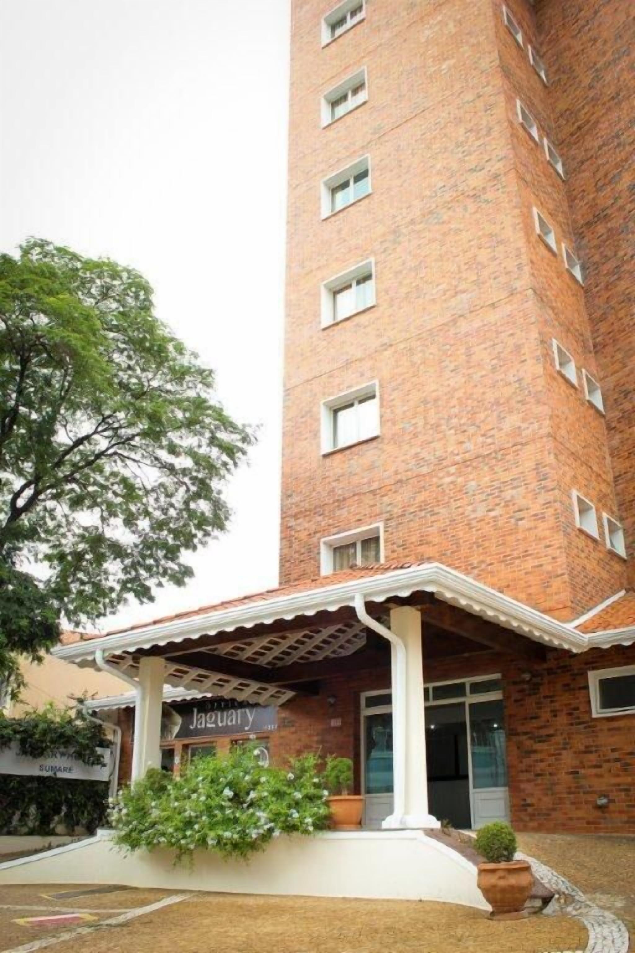 A brick building with a covered entrance and a sign that reads "Jaguary."