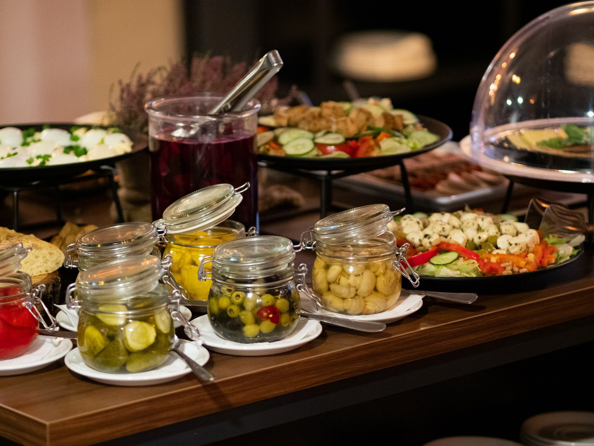 A buffet with various food items and condiments.