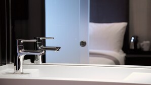A modern bathroom with a chrome faucet and a white sink. - The Z Hotel Victoria (London)