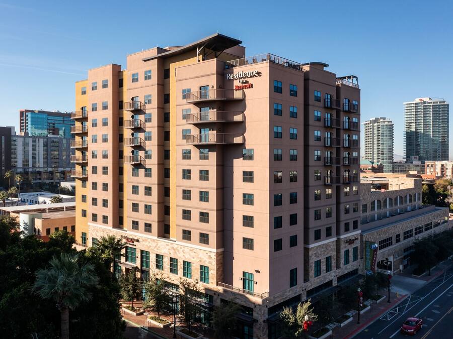 A multi-story hotel with a modern design, featuring balconies on the upper floors and a prominent sign indicating it is a Marriott hotel.