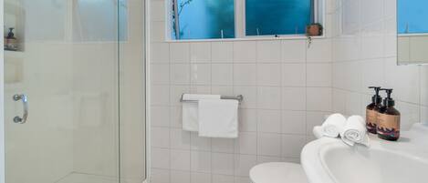 Ein Badezimmer mit Duschkabine, Toilette und Badewanne.