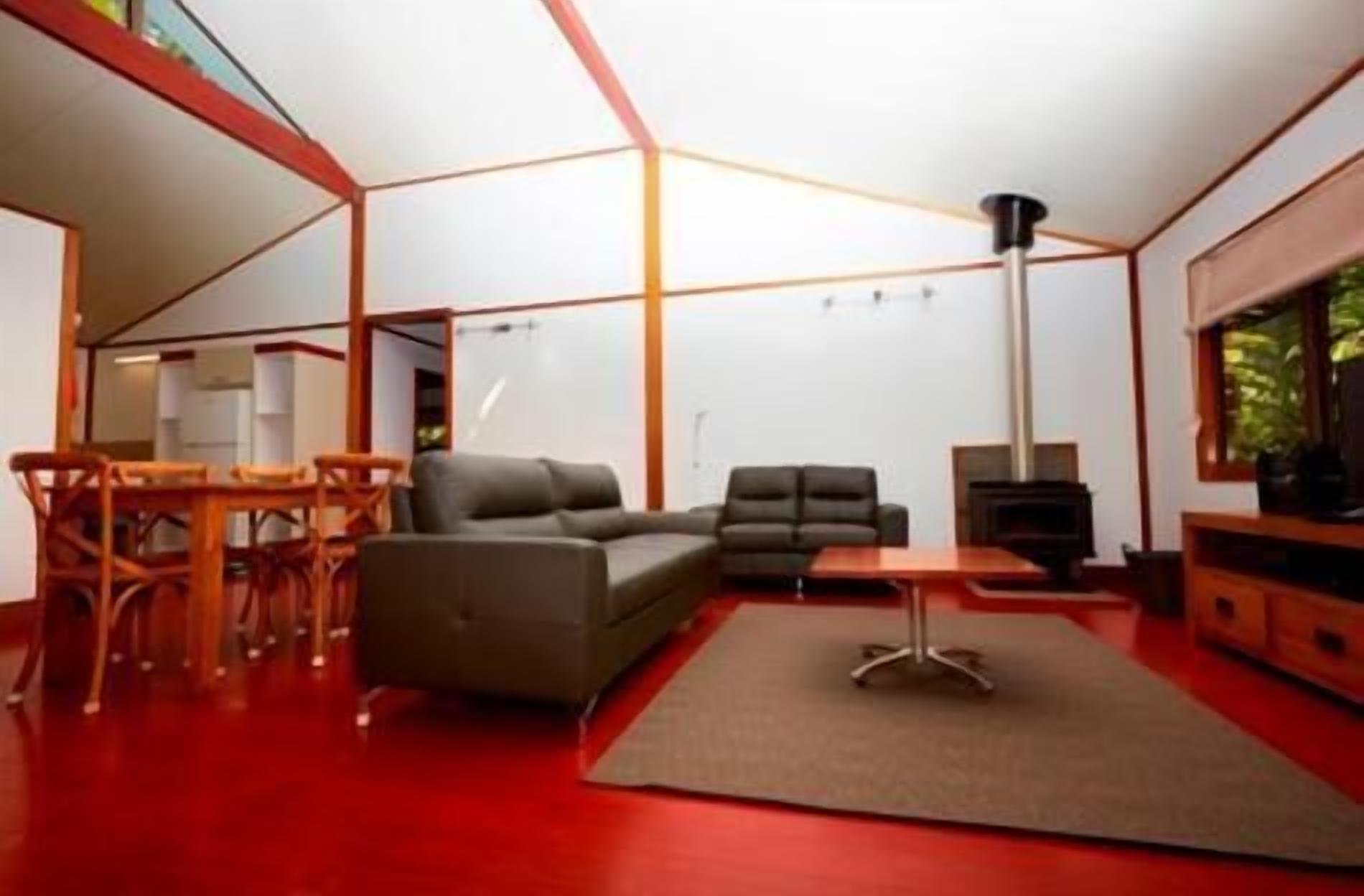 A modern living room with a sofa, a coffee table, and a fireplace.