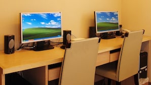 A computer desk with two monitors, a desktop computer, and two speakers. - Eastern Star Hotel (Taipei)