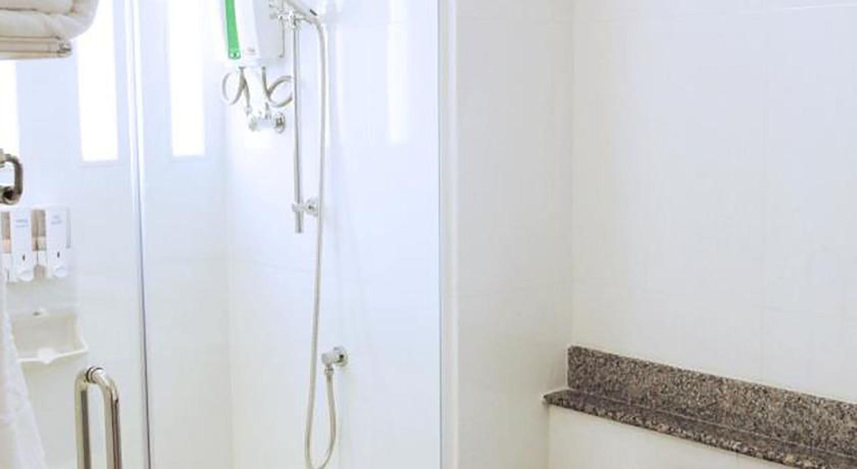 A bathroom with a shower, a toilet, and a sink.