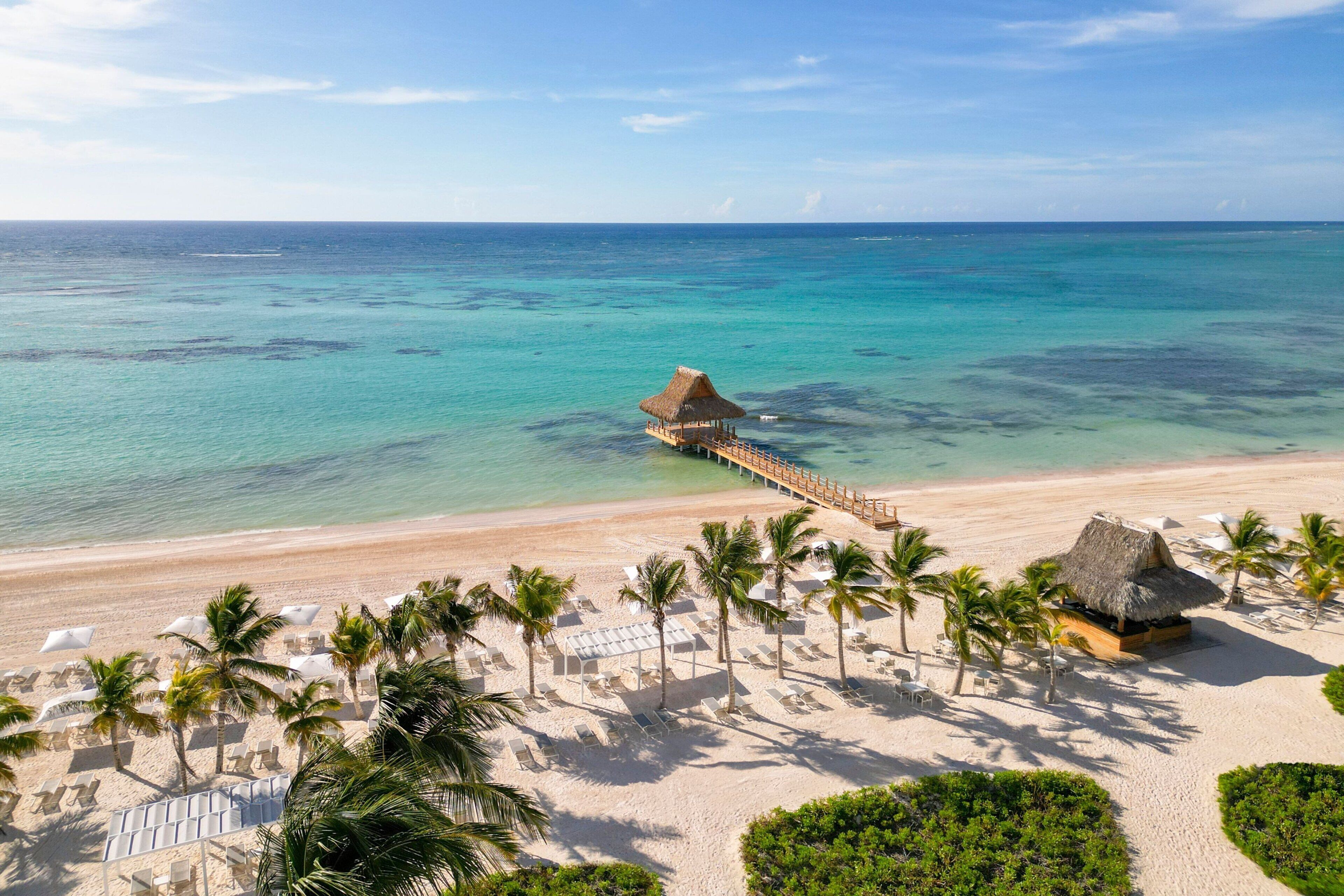 On the beach, white sand, sun loungers, beach umbrellas
