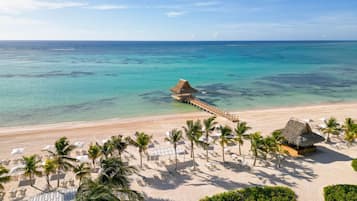 On the beach, white sand, sun loungers, beach umbrellas
